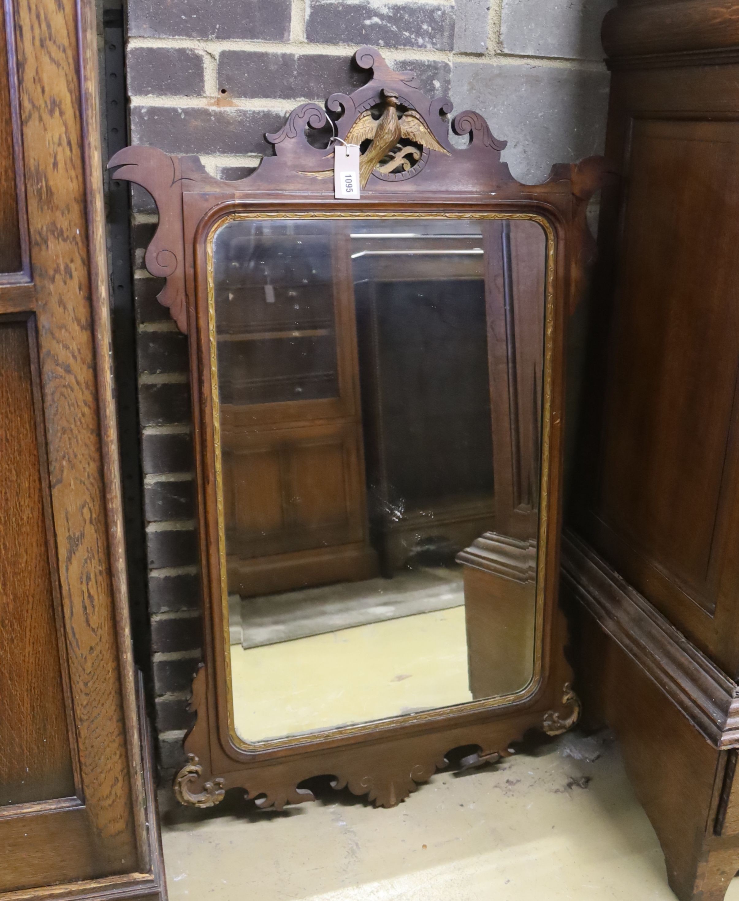 A George III style parcel gilt mahogany fret cut wall mirror, height 115cm